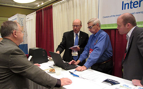 Interlink founder Bill Garber; Interlink customer Bill Tubbs, publisher of the North Scott Press in Iowa; NNA postal expert Max Heath; and Interlink General Manager Brad Hill